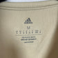 Close-up of Adidas logo and Ajax club badge on white third shirt from 2022/23 season