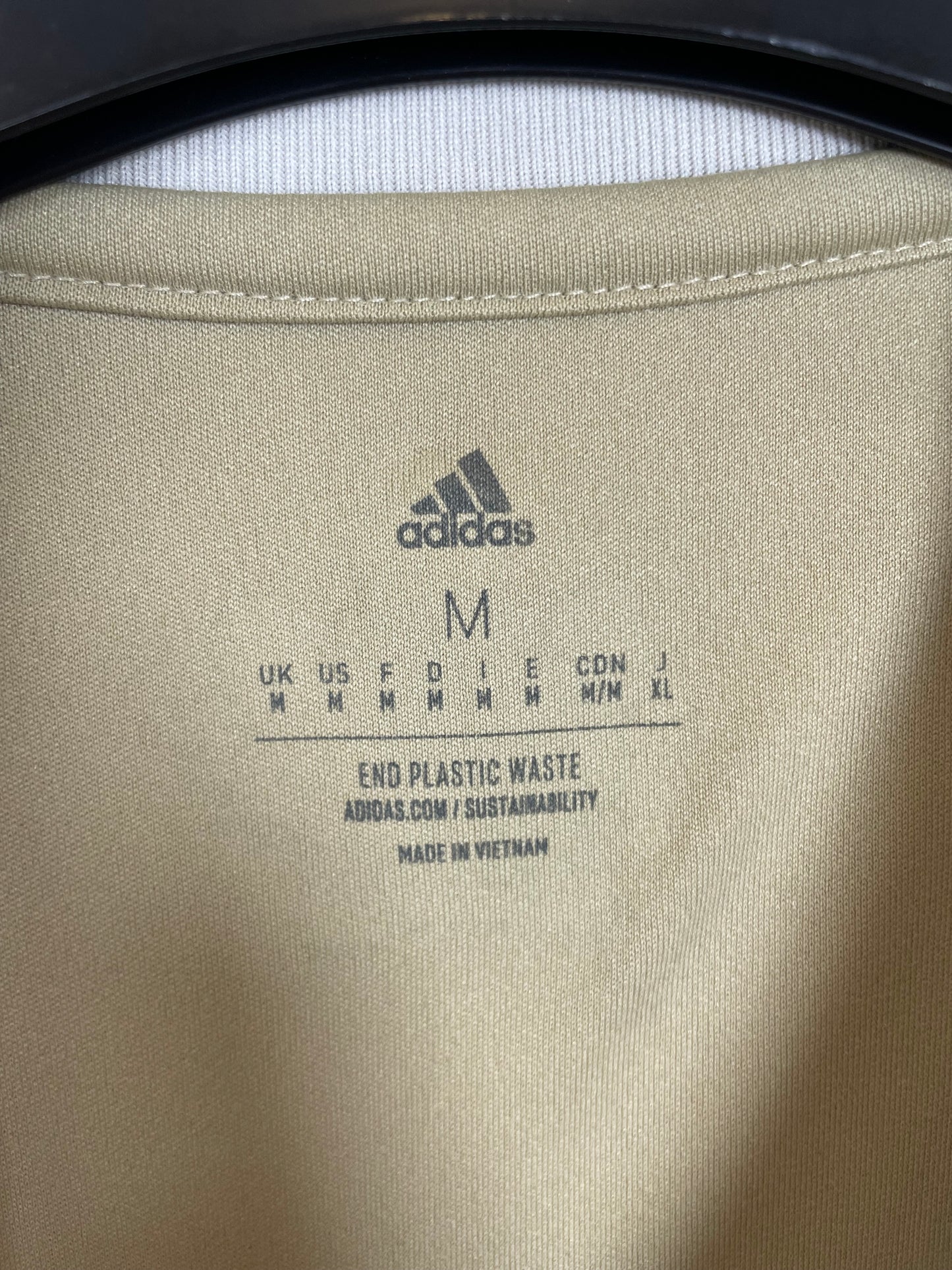 Close-up of Adidas logo and Ajax club badge on white third shirt from 2022/23 season
