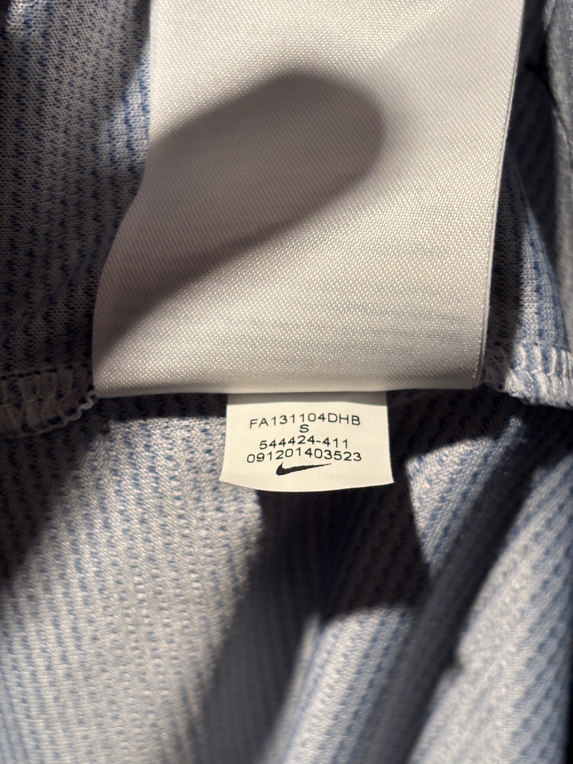 Close-up of a Nike label on a gray fabric surface