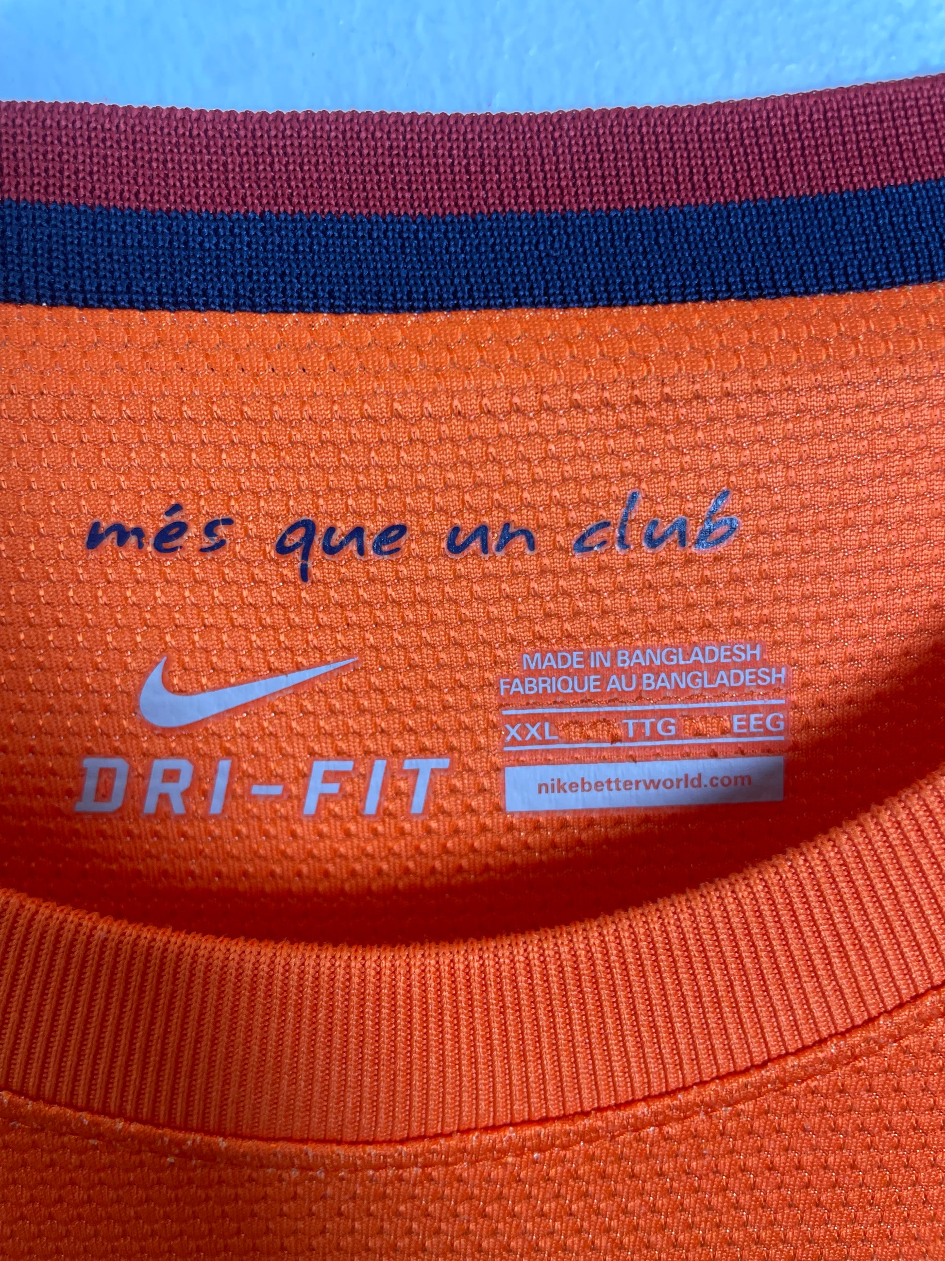 Close-up of Nike swoosh logo and FC Barcelona club crest on 12/13 away kit