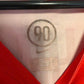 Close-up of Nike swoosh logo and Juventus club badge on white 05/07 away shirt