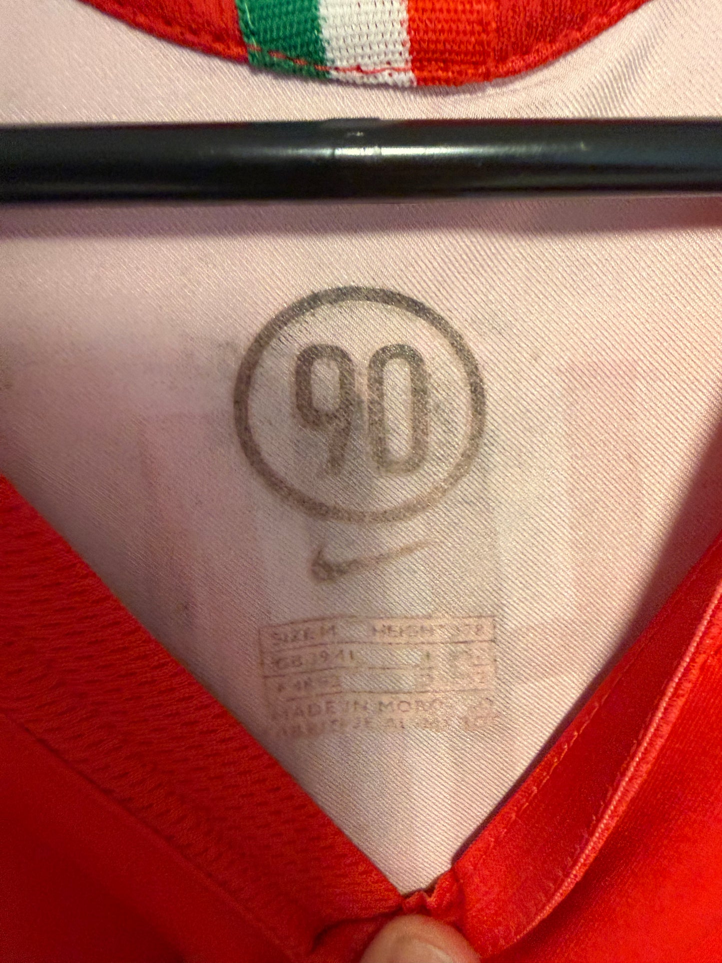 Close-up of Nike swoosh logo and Juventus club badge on white 05/07 away shirt