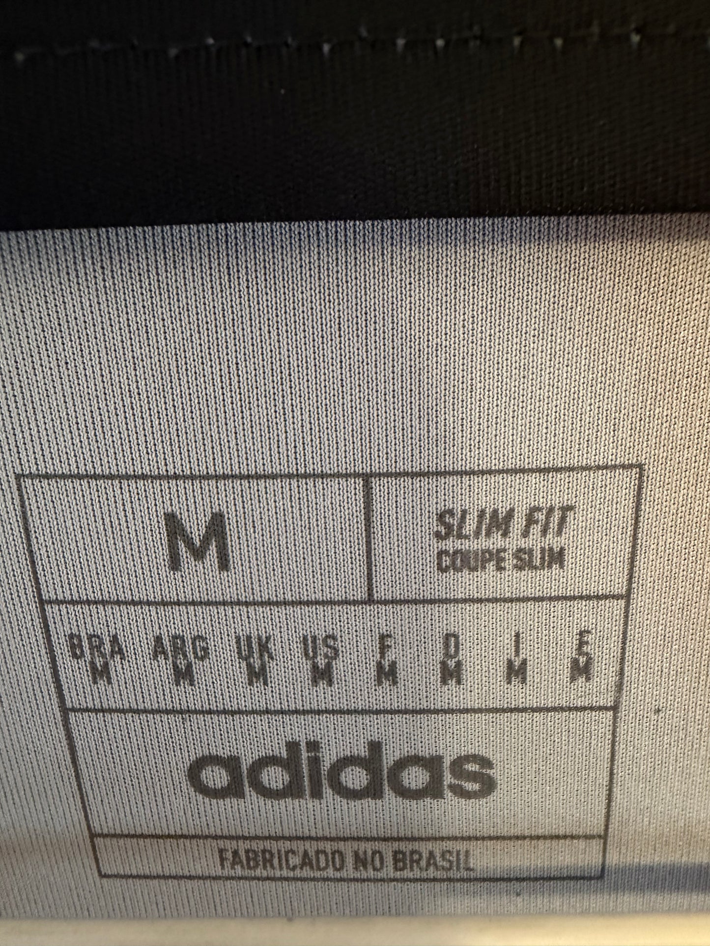 Close-up of River Plate club crest and Adidas three stripes logo on 2025 fourth jersey