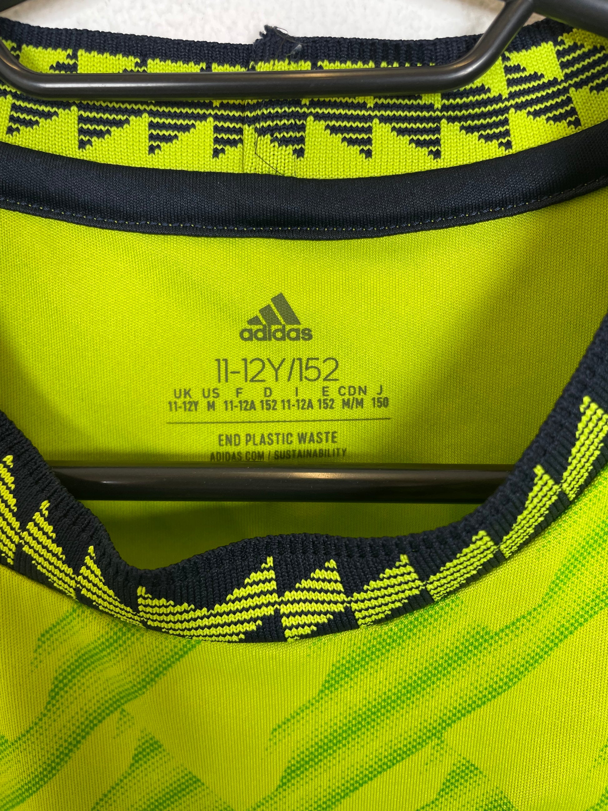 Close-up of Manchester United third shirt 22/23 showing club badge and shirt details