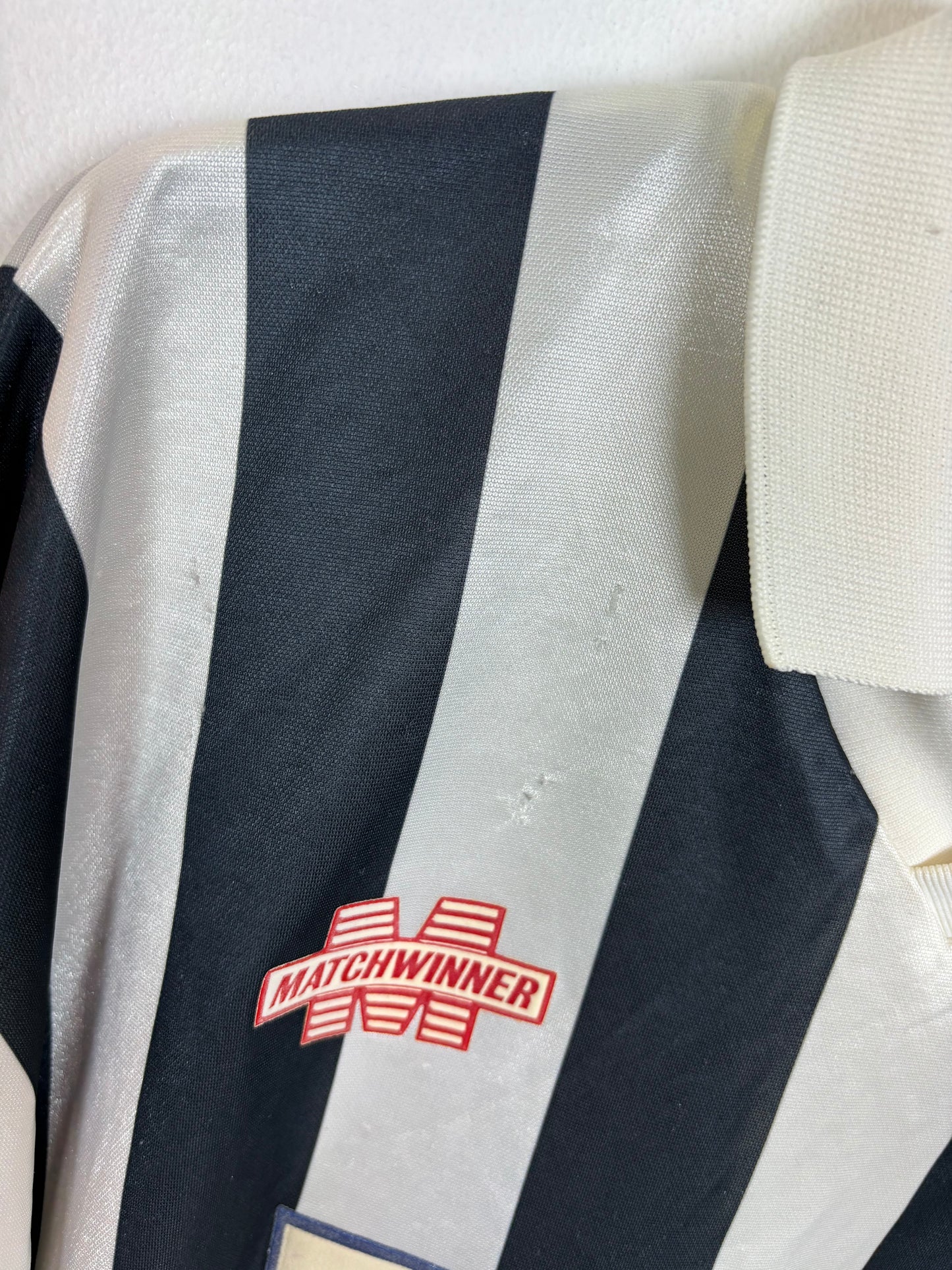 Close-up of Matchwinner logo and St Mirren club badge on 1993/94 home shirt