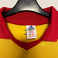 Yellow sports jersey with red collar on a hanger, featuring Adidas logo.