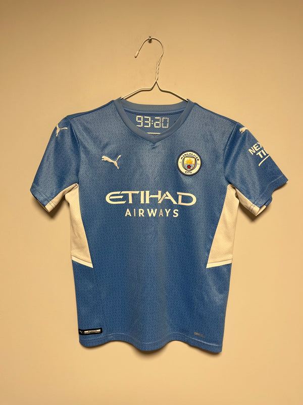 Blue Manchester City Home with visible branding on a beige background