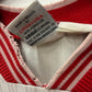 Close-up of a red and white striped fabric with a label on a white background