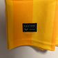Yellow fabric with a black label on a gray background