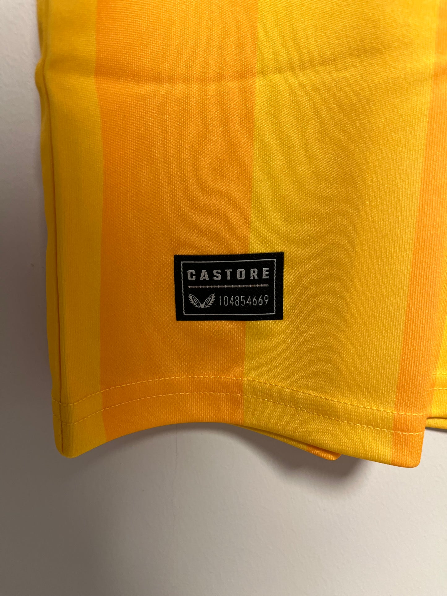 Yellow fabric with a black label on a gray background