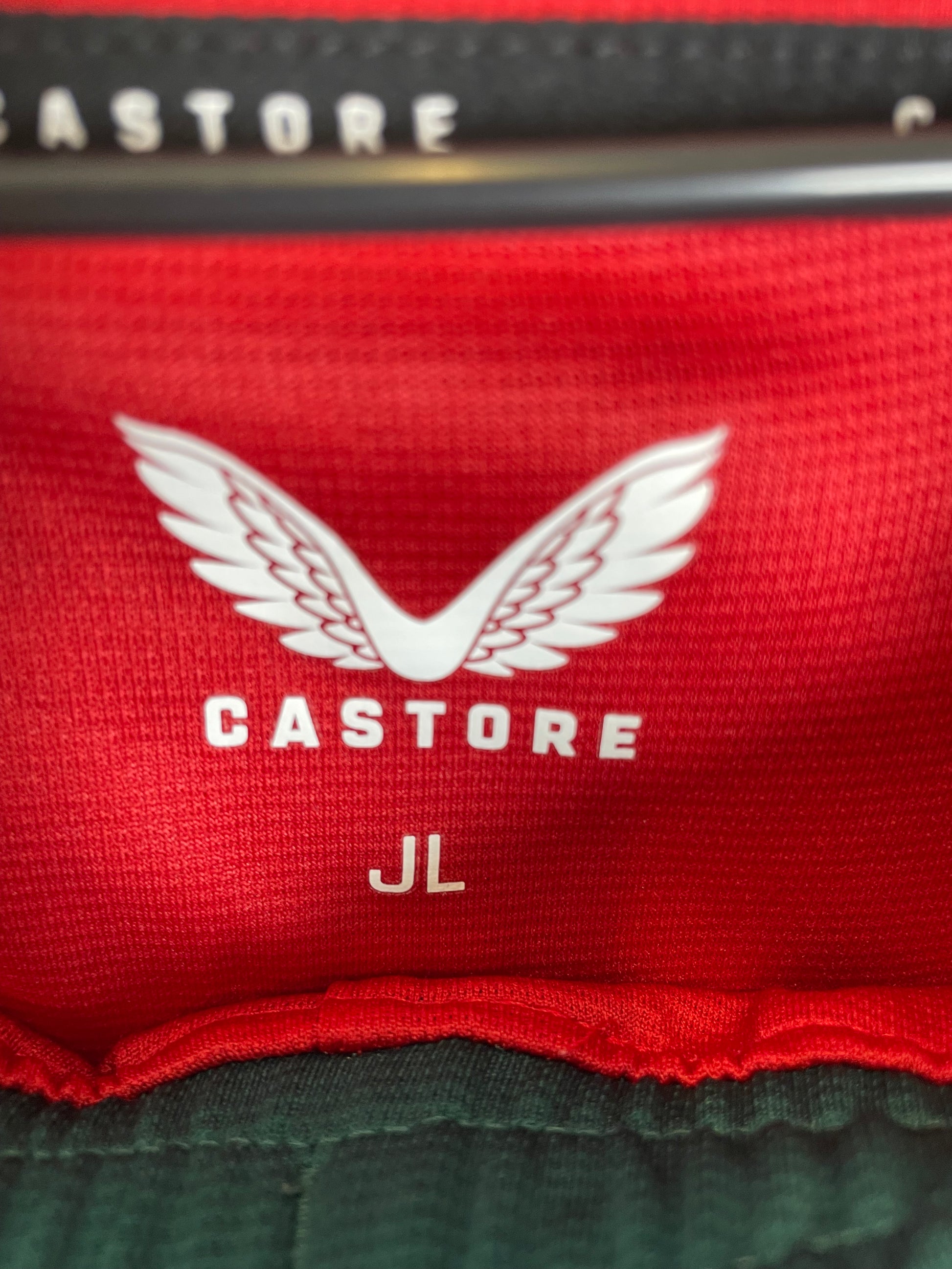 Close-up of Wolves club badge and shirt sponsor details on orange 23/24 away kit