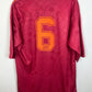 Maroon as roma fotballdrakt with number 6 and 'Asics' branding on a white background
