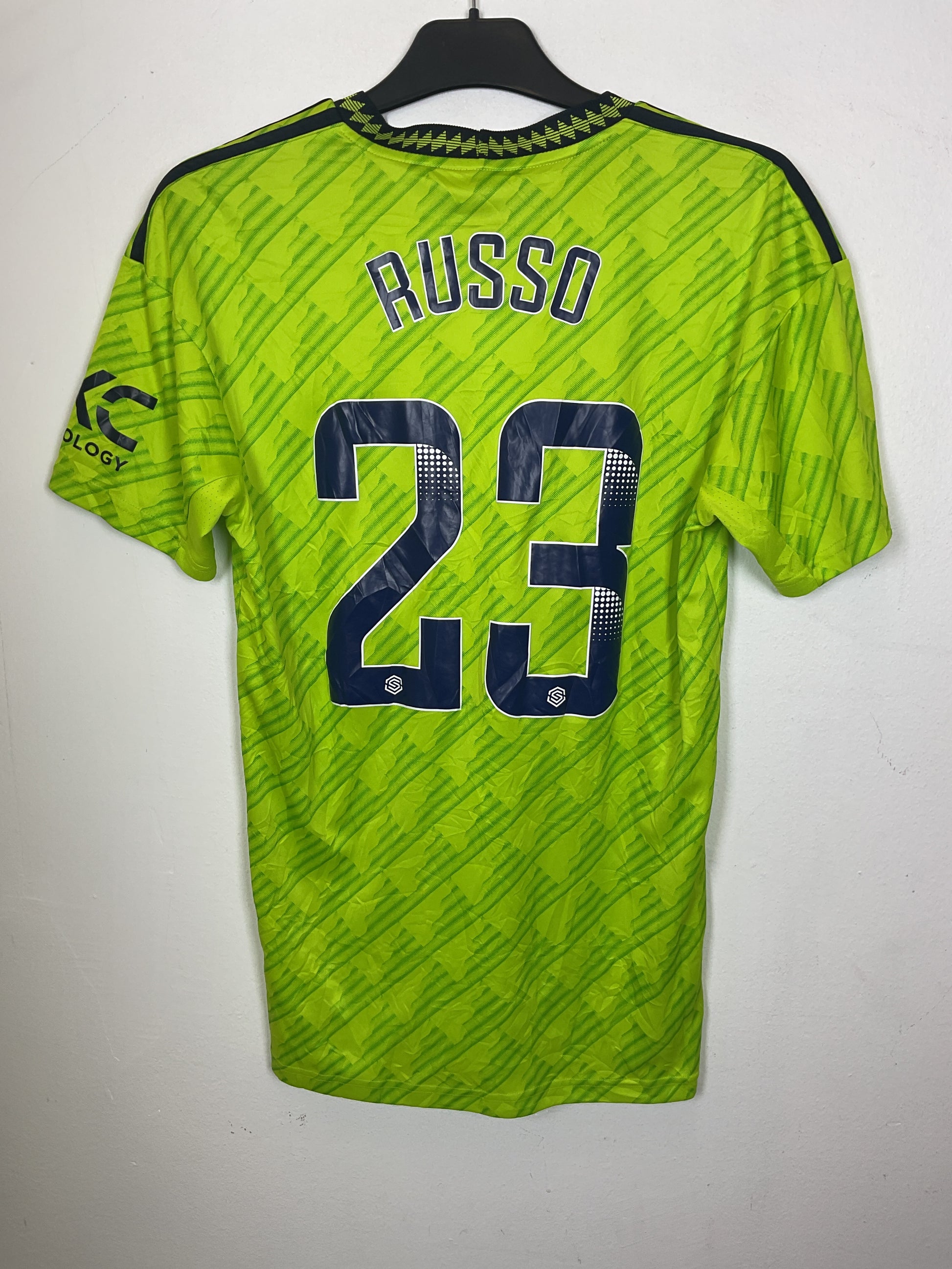 Green Adidas women's jersey with black text on a white background