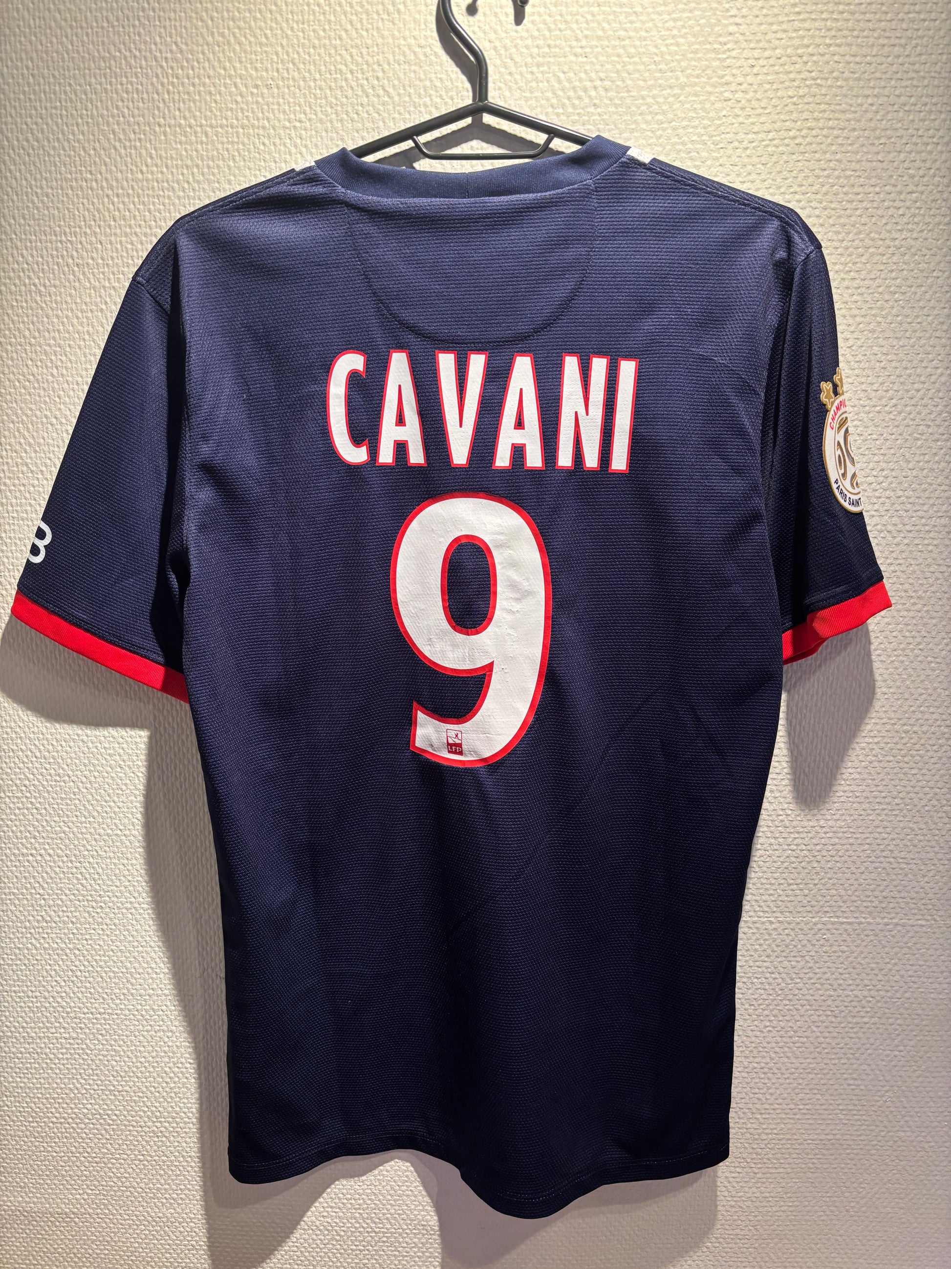 Navy football  jersey with 'Cavani' and number '9' on a beige background