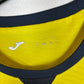 Close-up of Joma logo and Villarreal club badge on yellow 23/24 home shirt with R. Albiol 3