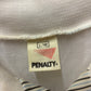 Close-up of a Penalty brand label on a textured fabric surface.