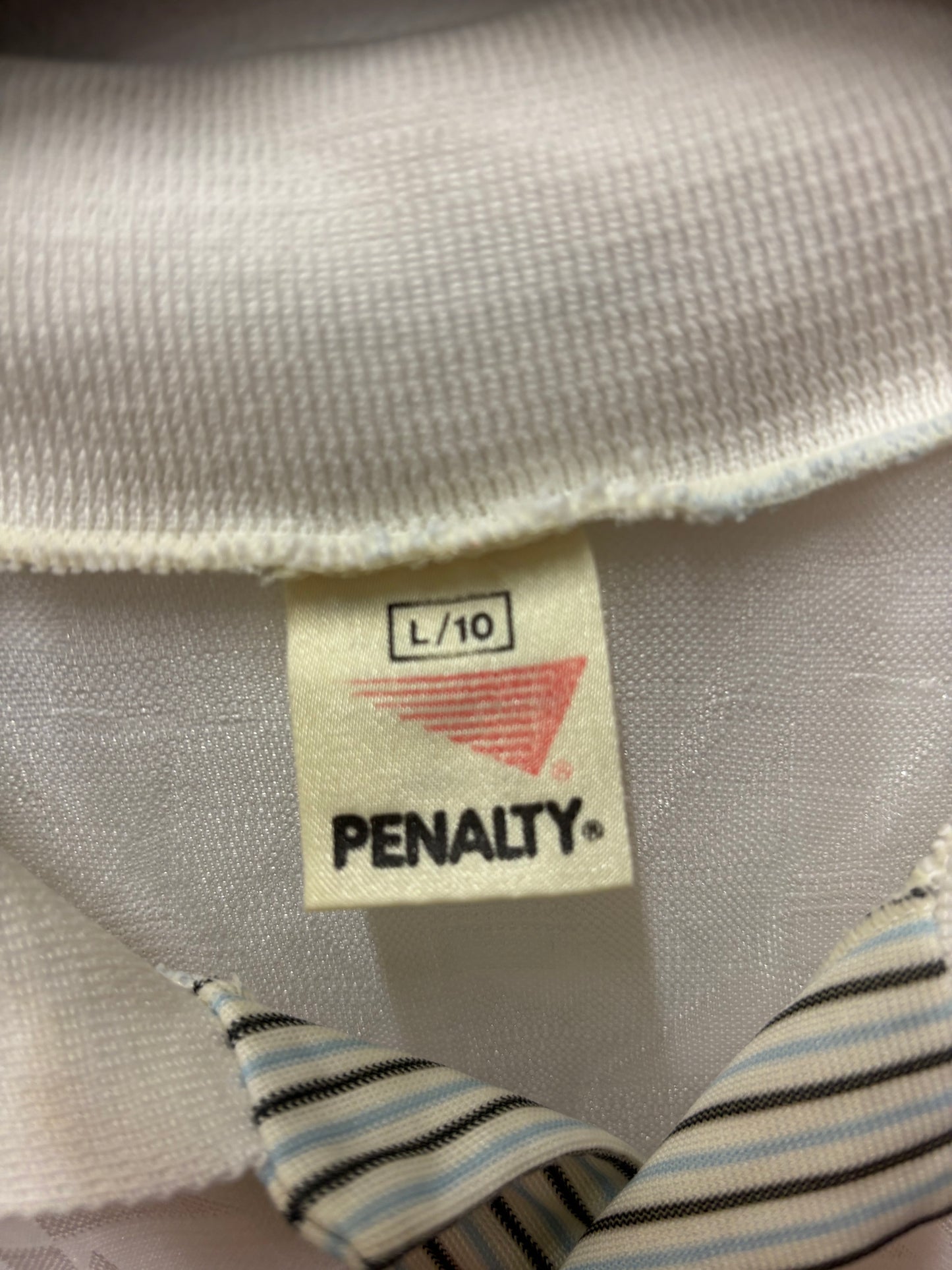 Close-up of a Penalty brand label on a textured fabric surface.