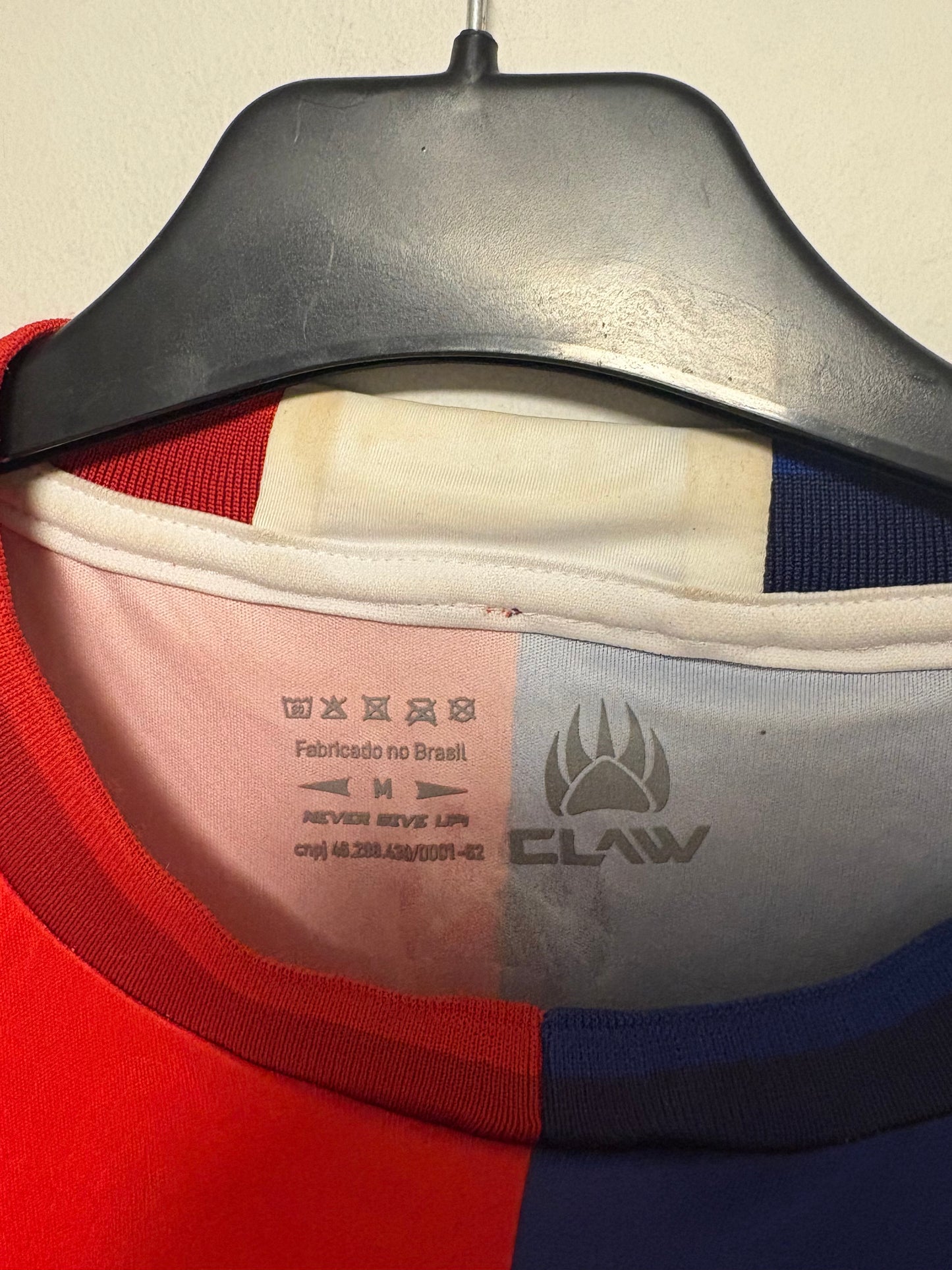 Close-up of the Paraná Clube club crest and Claw branding on the 2024 home football shirt