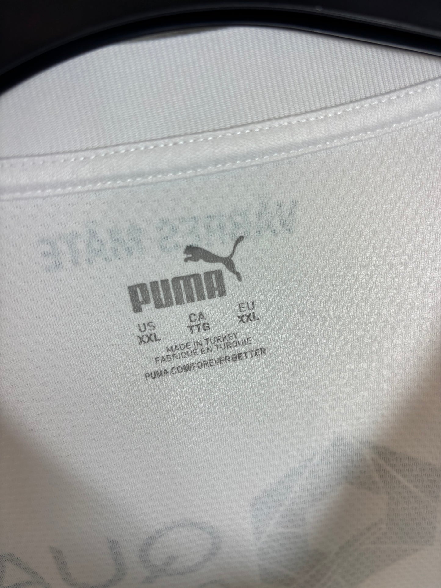 Close-up of Puma logo and Bodo/Glimt club badge on 2025 third shirt with Gronbaek 8
