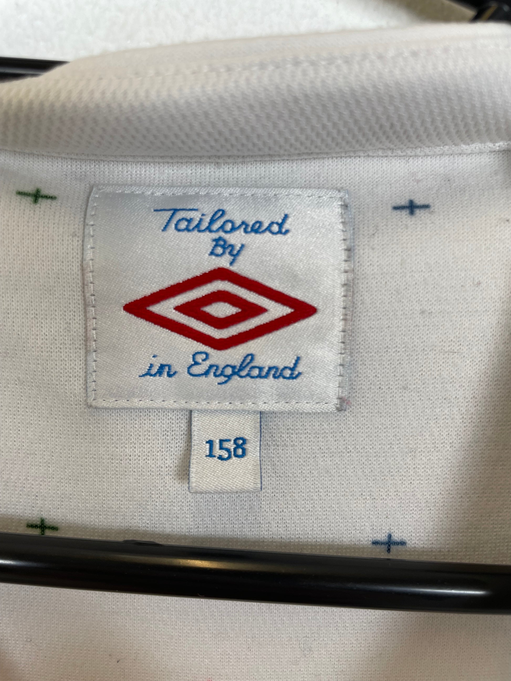 Close-up of Umbro logo and England national team crest on white 2010 home shirt with Terry 6