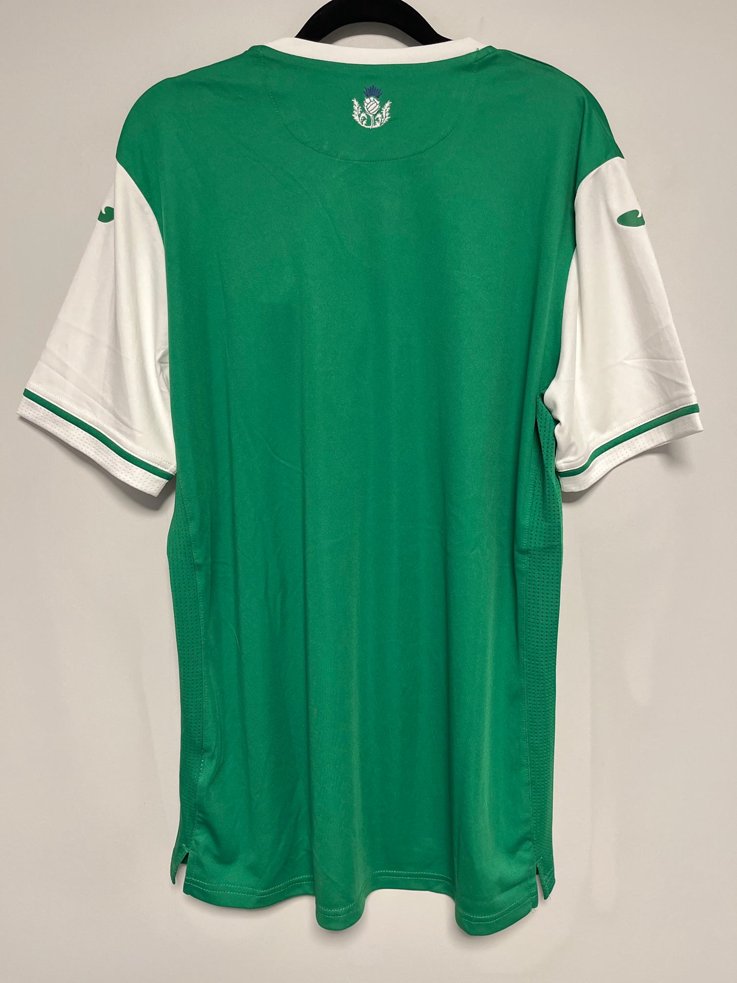 Green scotish premiership jersey with white accents on a gray background