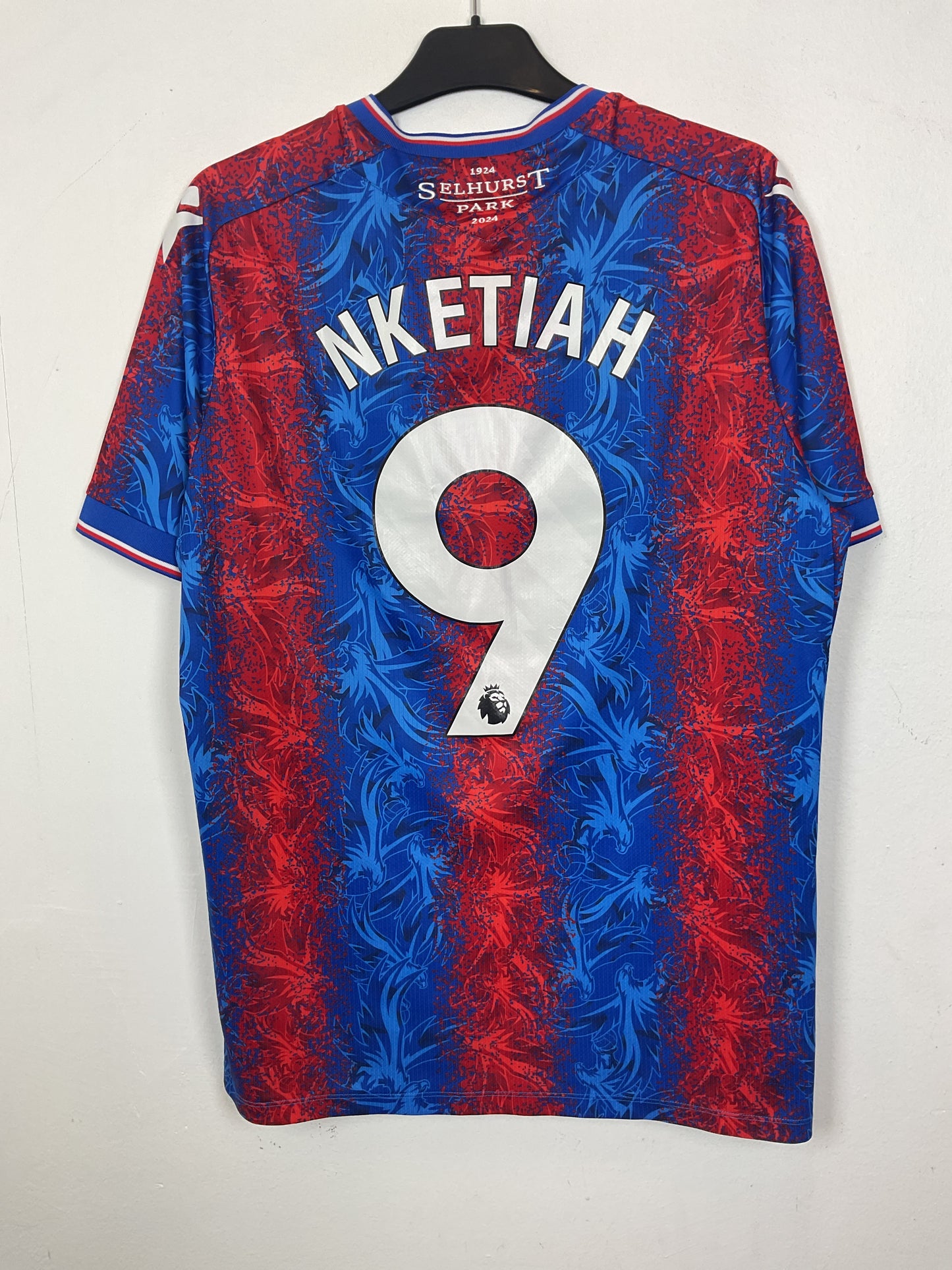 Blue and red english premier league t shirts with white logo and text on a light gray background