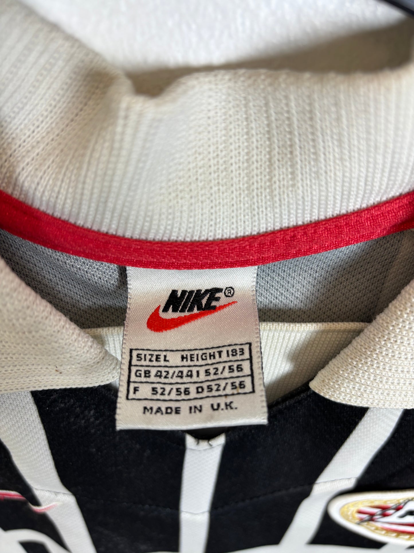 Close-up of PSV Eindhoven club badge and Nike swoosh logo on 1997/98 away shirt