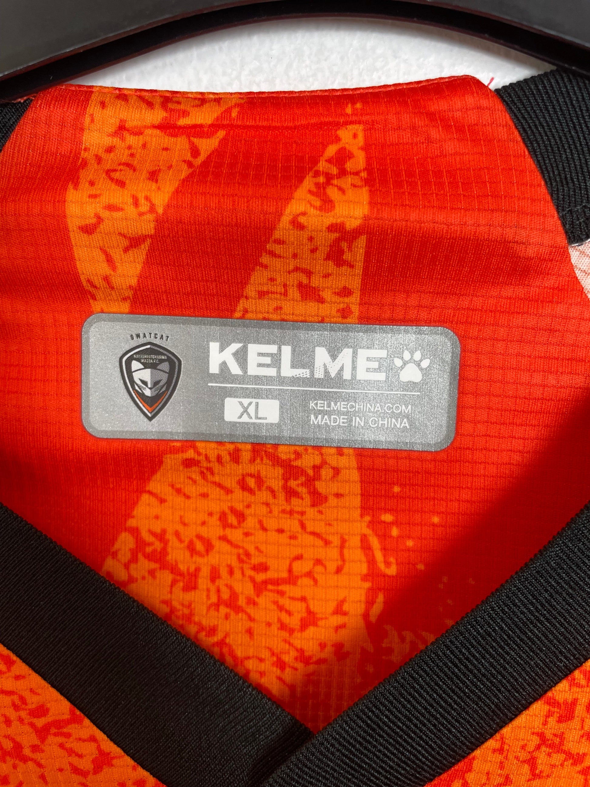 Close-up of Kelme brand logo and Nakhon Ratchasima FC club badge on 2021/22 shirt