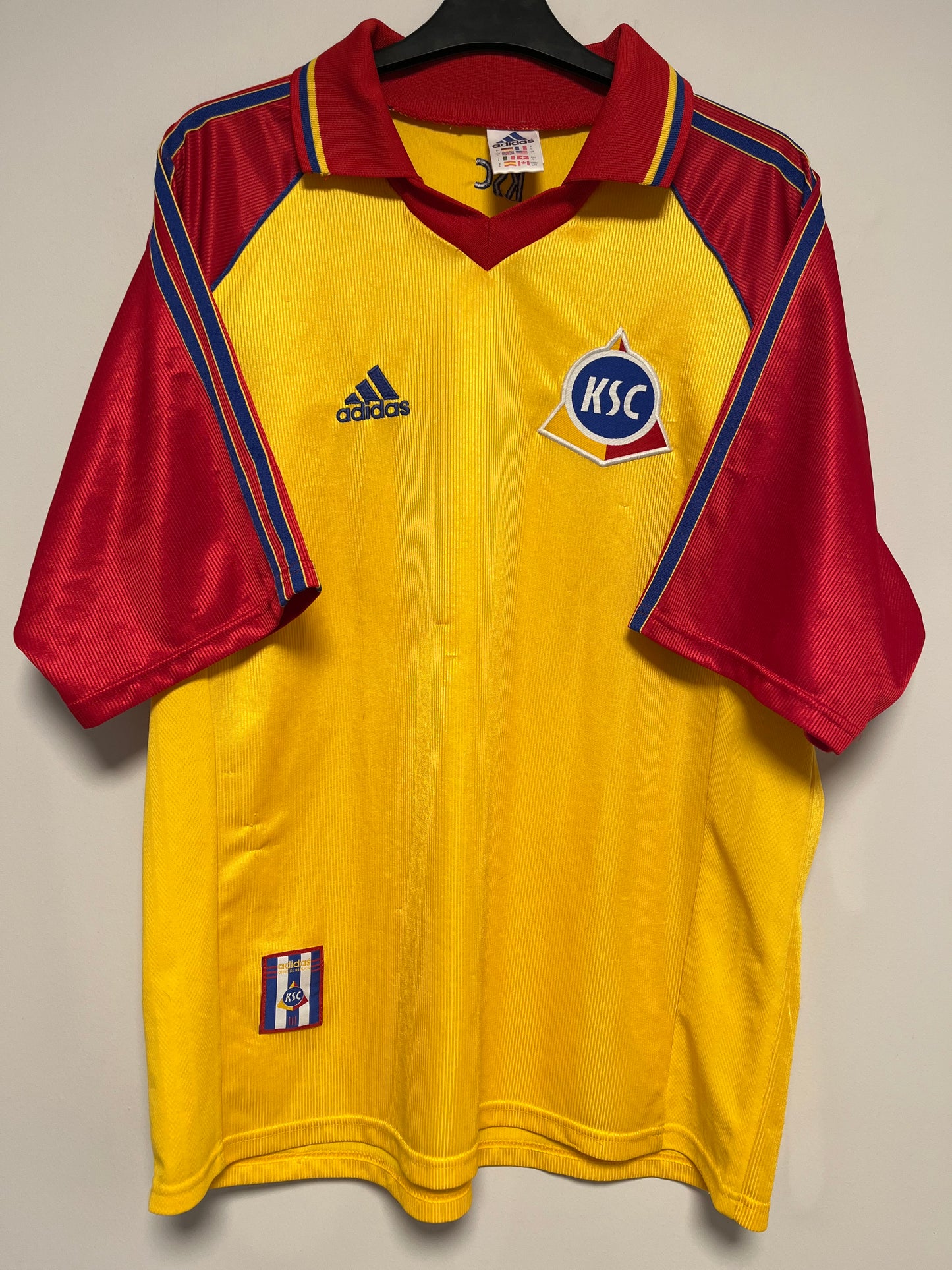 Yellow and red Karlsruher jersey with Adidas logo on a neutral background