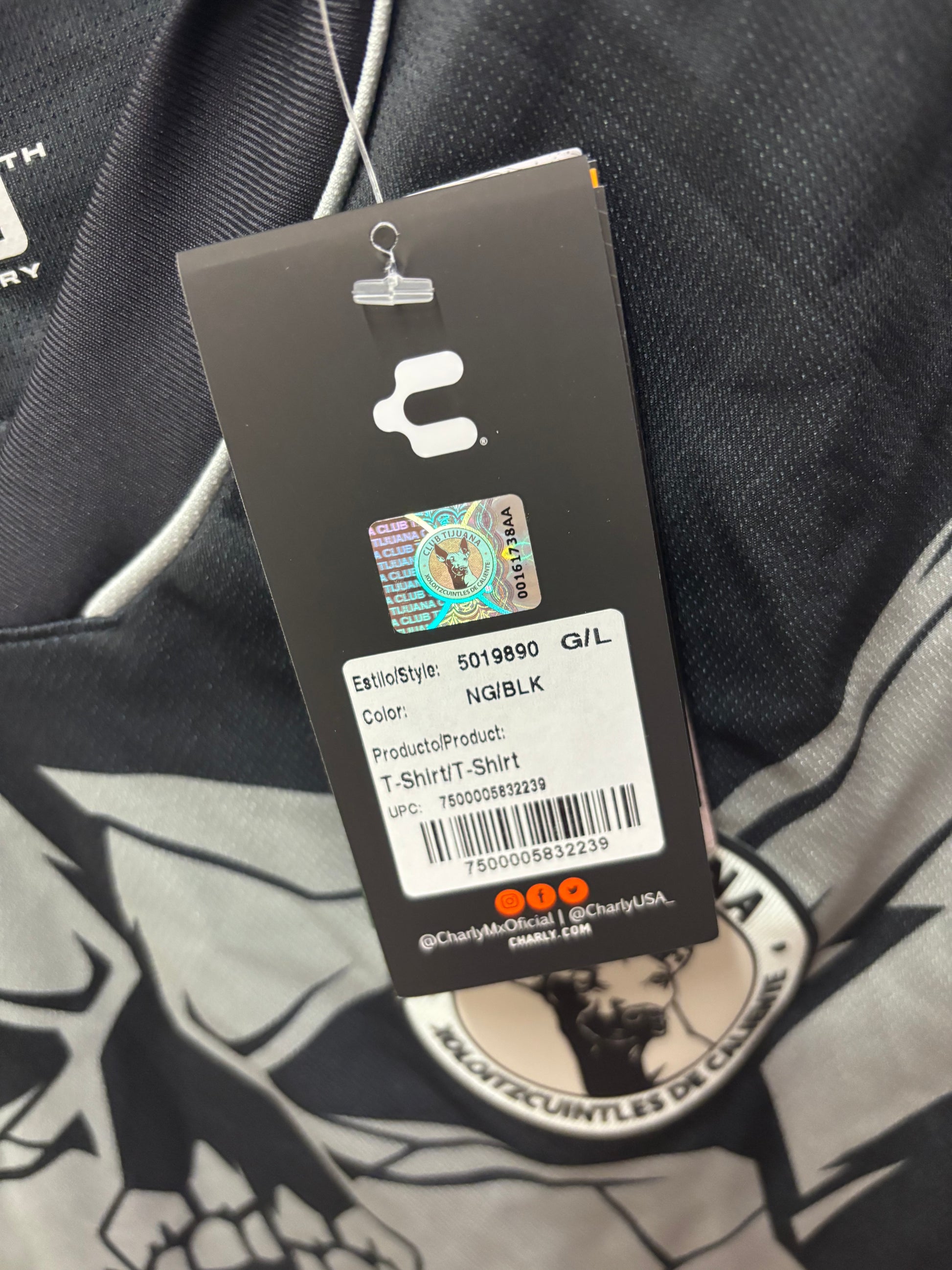 Close-up of a clothing tag with brand logo on a garment background