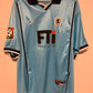 Light blue 80s football jersey with black accents on a peach background