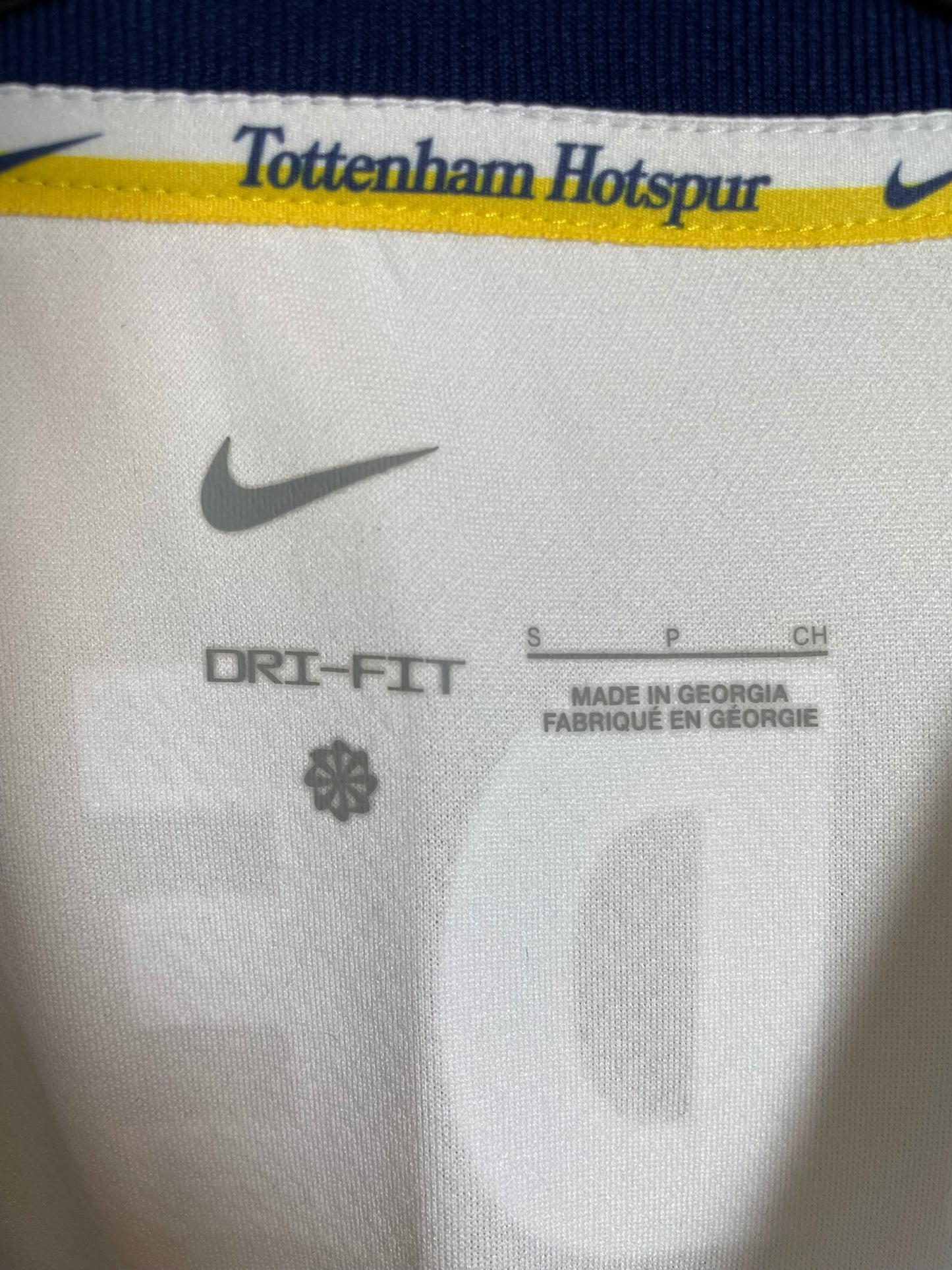 Close-up of Nike logo and Tottenham Hotspur club badge on white 24/25 home shirt