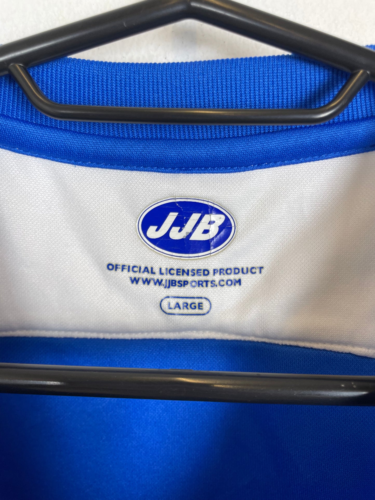 Close-up of a product with a visible brand logo and text on a white and blue background.