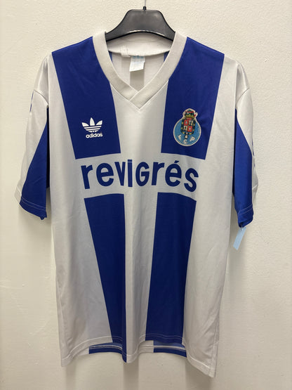 White and blue Adidas FC Porto home shirt  with visible branding on a light background