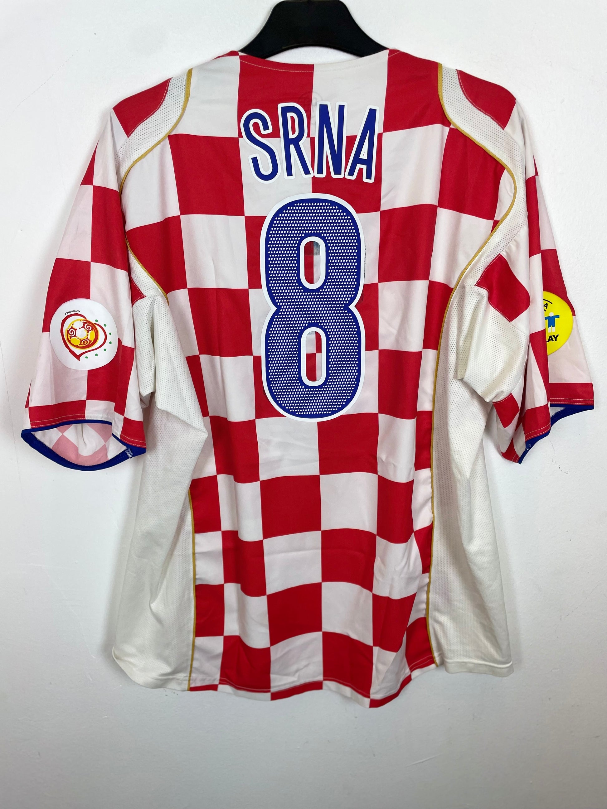 Red and white checkered sports jersey with 'SrinA' and number '8' on a white background