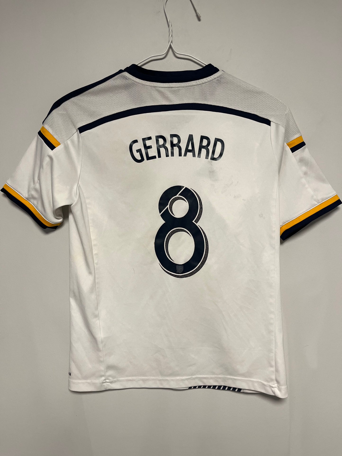 White sports jersey with 'Gerrard' and number '8' on a gray background