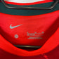 Close-up of Liverpool club badge and sponsor logo on red 21/22 home shirt with Salah 11