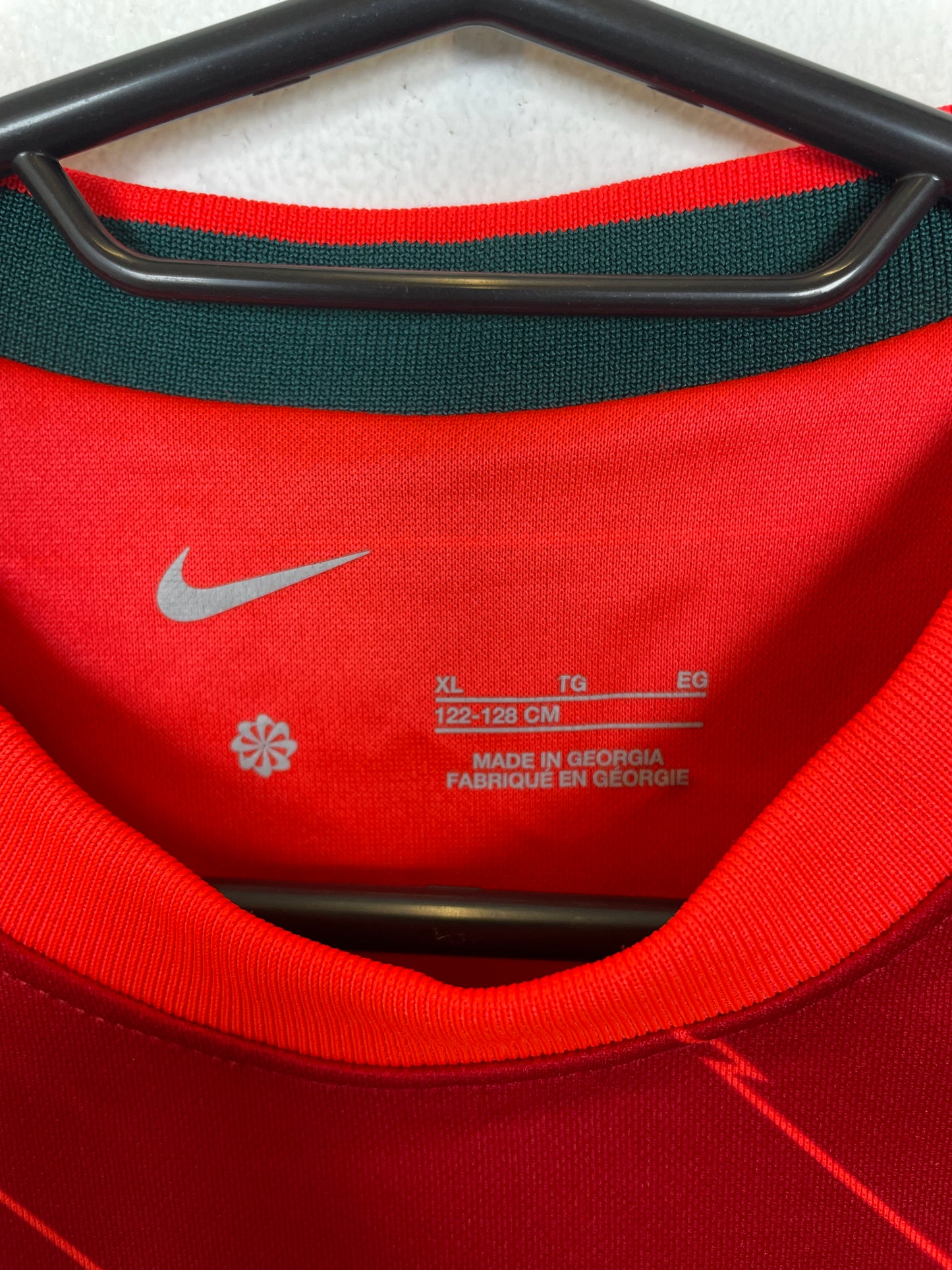 Close-up of Liverpool club badge and sponsor logo on red 21/22 home shirt with Salah 11