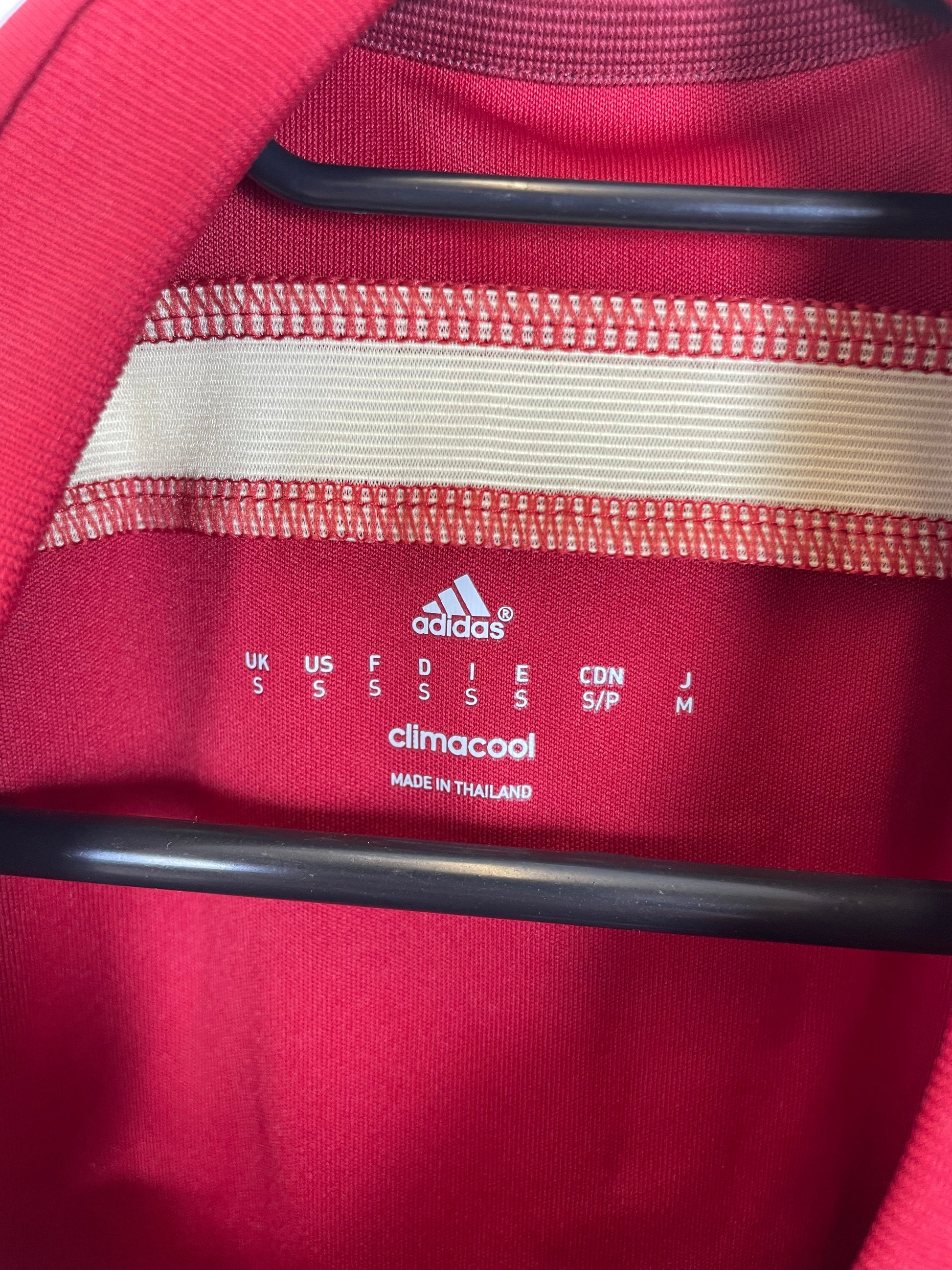 Spanish Football Federation badge and Adidas three stripes detail on 2014 World Cup home shirt
