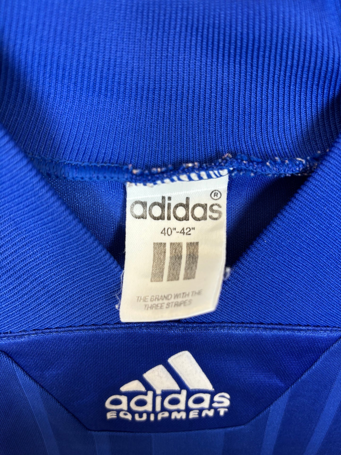 Close-up of Adidas logo and France national team badge on 1992 home shirt with Sauzee 8