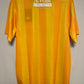 Yellow football jersey with a visible brand label on a gray background