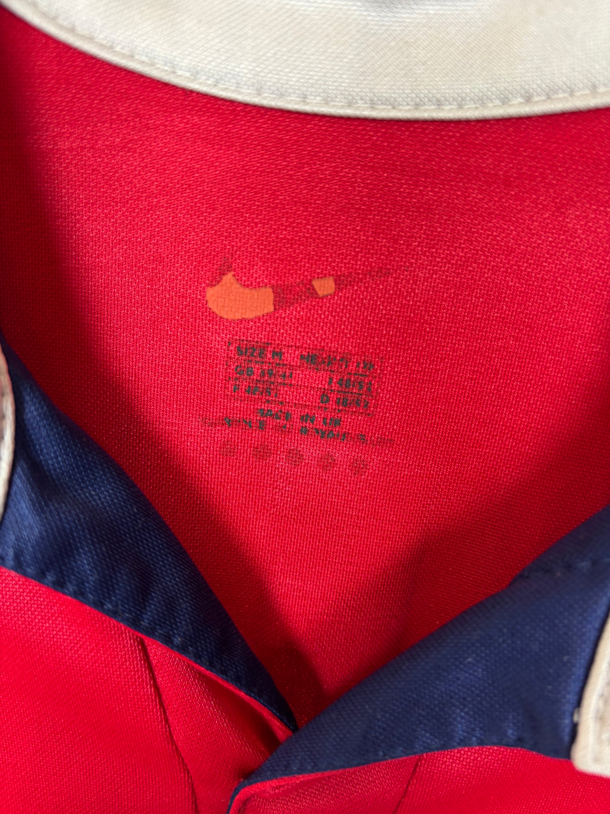 Close-up of Nike swoosh logo and Arsenal club crest on red 99/00 home jersey