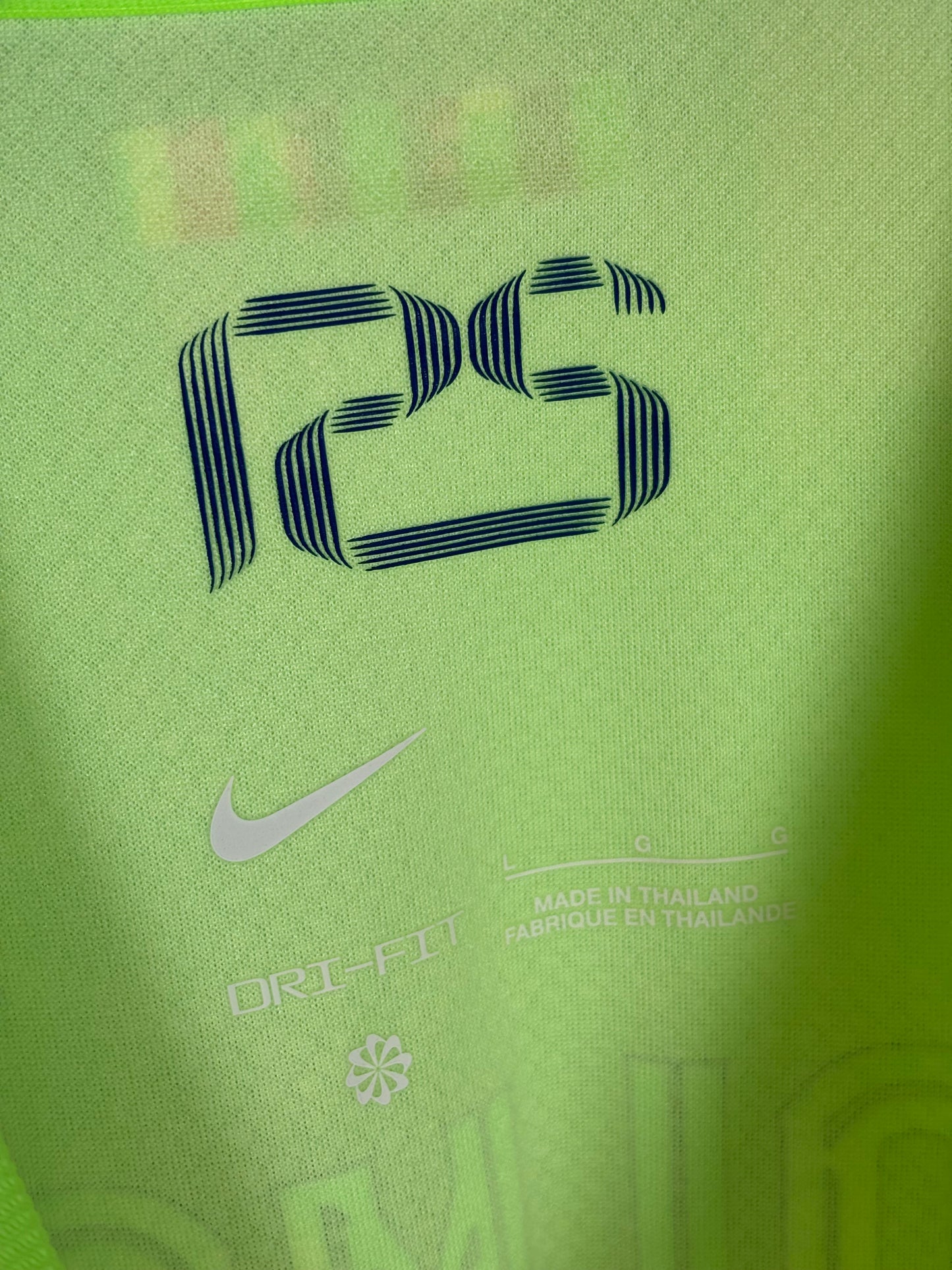 Close-up detail of FC Barcelona club crest and Nike logo on 2024/25 third jersey, mint condition