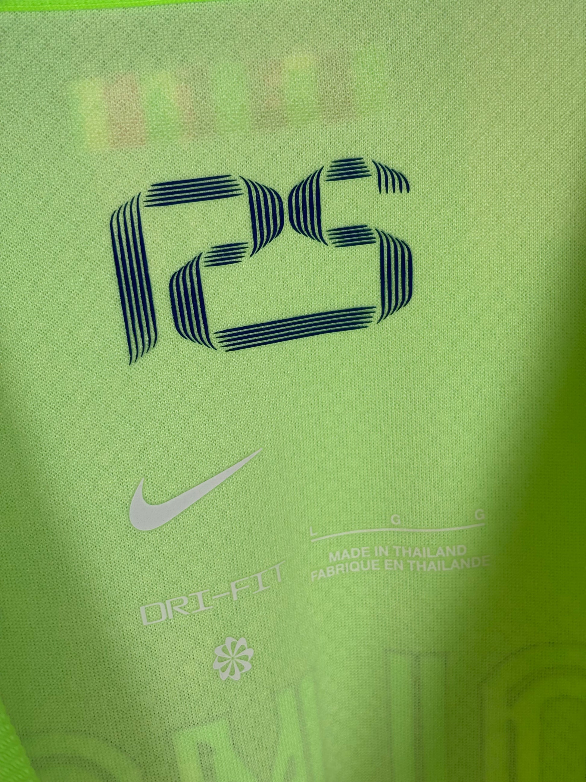Close-up detail of FC Barcelona club crest and Nike logo on 2024/25 third jersey, mint condition