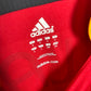 Close-up of Adidas logo and Germany national team badge on 2006 away shirt