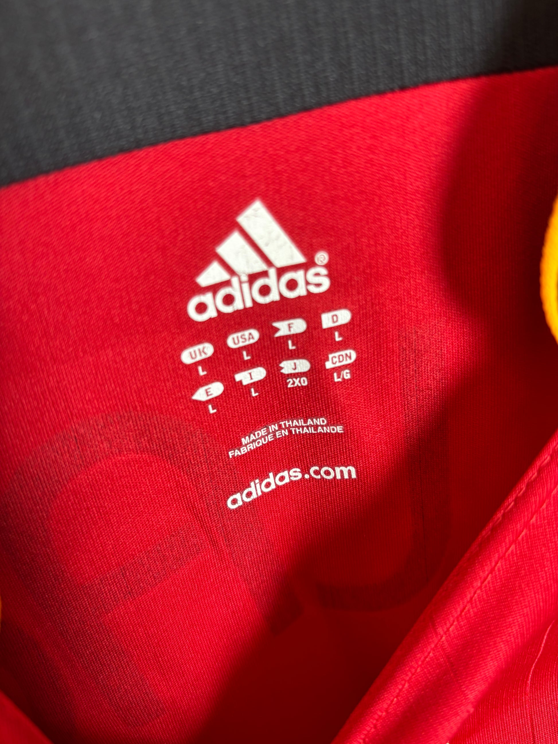 Close-up of Adidas logo and Germany national team badge on 2006 away shirt