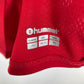 Close-up of Hummel logo and Denmark national team badge on red and white 22/23 home shirt