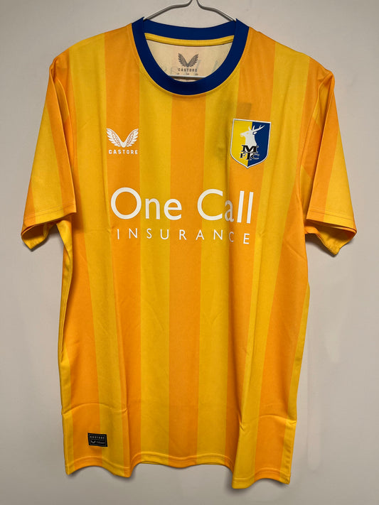 Yellow mainfield town jersey with branding on a gray background