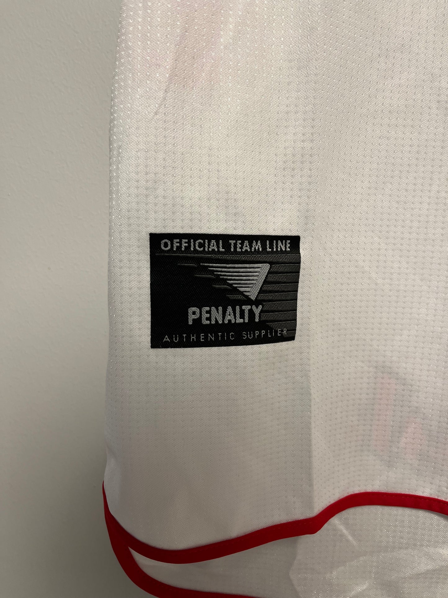 Close-up of a sao pulo jersey with a brand label on a white background