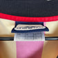 Close-up of Umbro logo and Galatasaray club badge on red and yellow striped home shirt